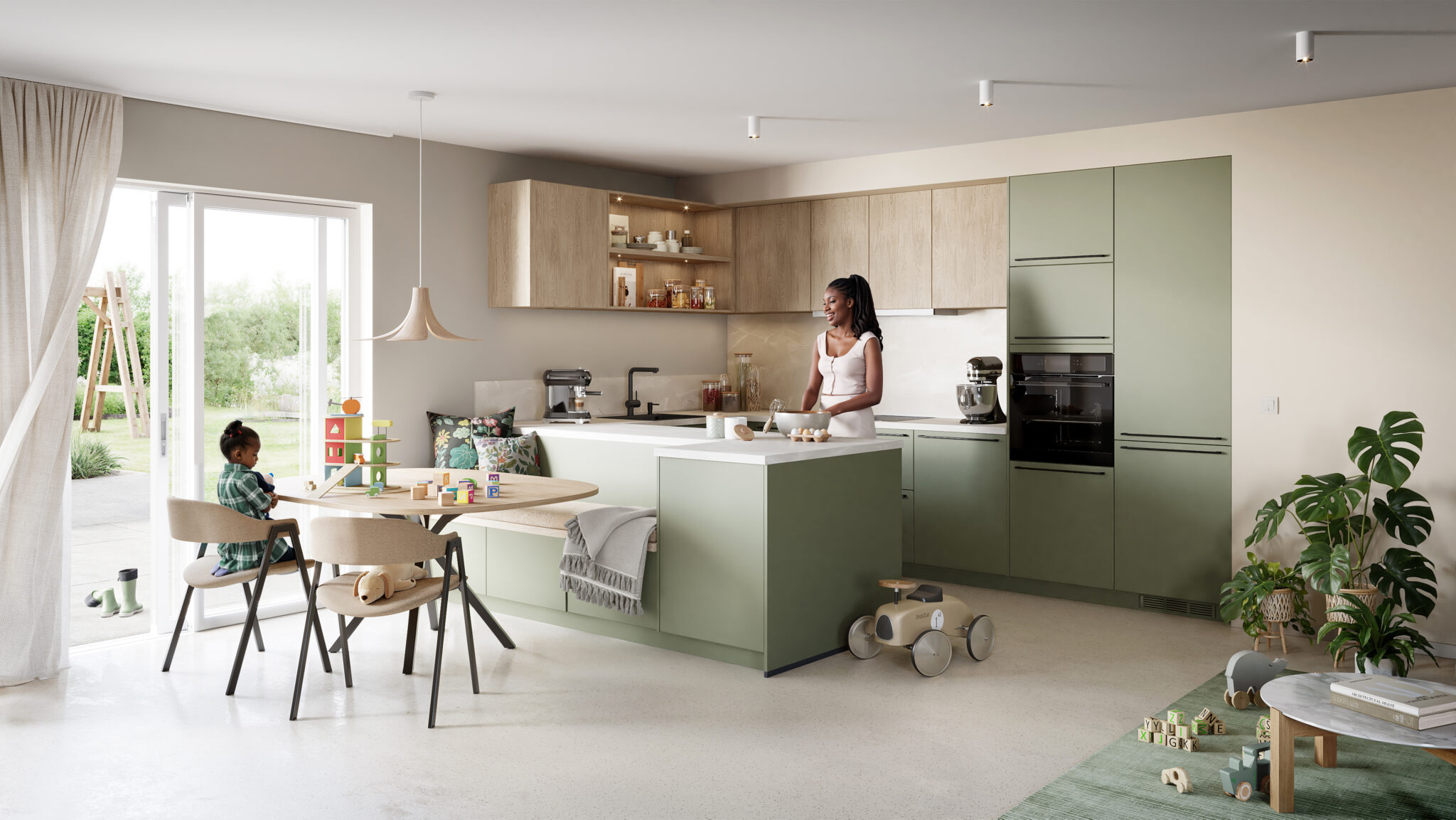 Cuisine moderne avec un îlot central vert, femme debout, et enfant jouant à une table avec des blocs en bois colorés.